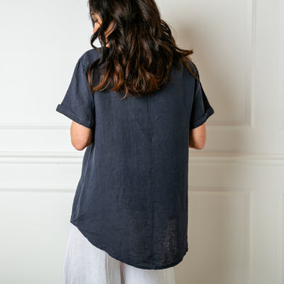 The navy blue Button Down Linen Top made from 100% linen, perfect for a lightweight, cool summer look